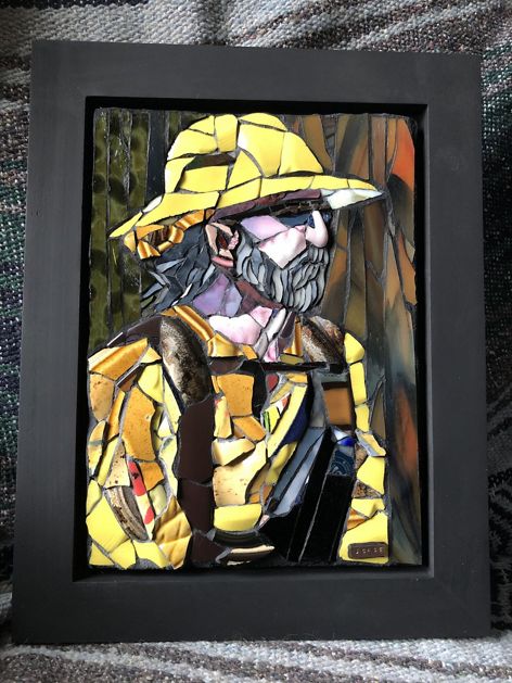 A tile mosaic work of art in the shape of a person wearing a fire suit.