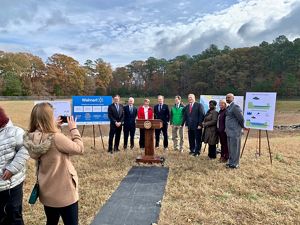 A group of people pose outdoors for a photo during a public event.