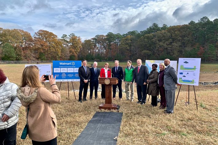A group of people pose outdoors for a photo during a public event.