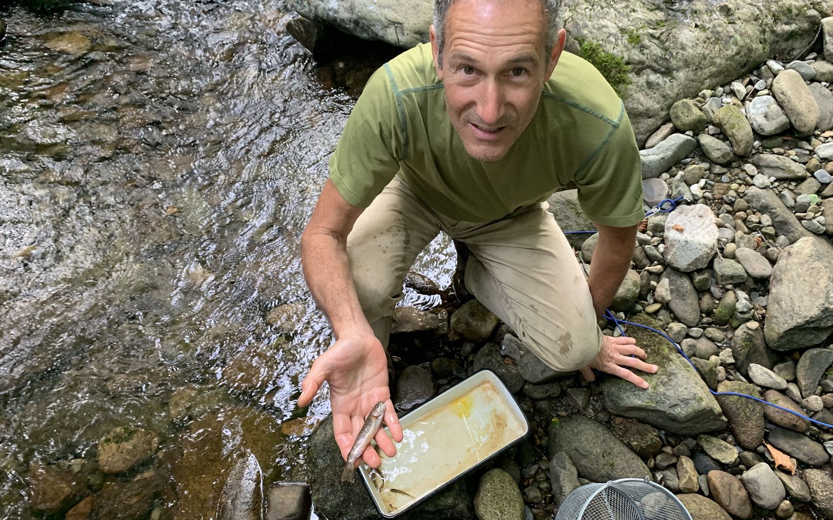 Stream Species Joshua Royte holds a brook trout captured in a fish trap. © Kira Bennett Hamilton/TNC