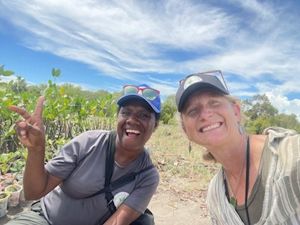 Two women smile and pose for a selfie.