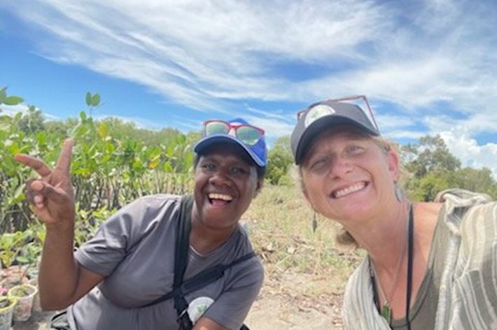 Two women smile and pose for a selfie.