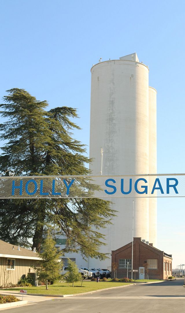 A silo with a Holly Sugar sign in the foreground.