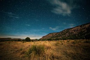 Stars emerging above the mesa at Black Mesa State Park and Nature Preserve.