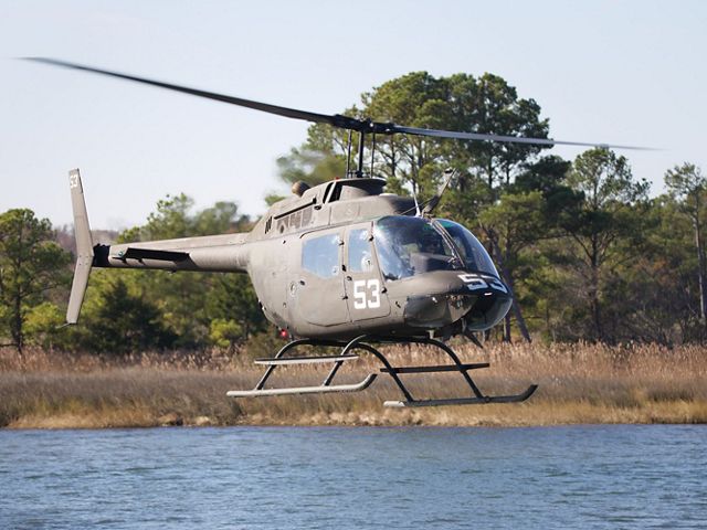 A US Navy helicopter flies low over a body of water on the Maryland coast during a training exercise.