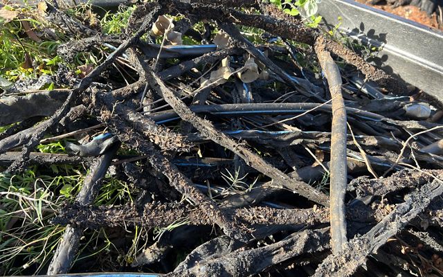 a bile of burnt wood and debris.