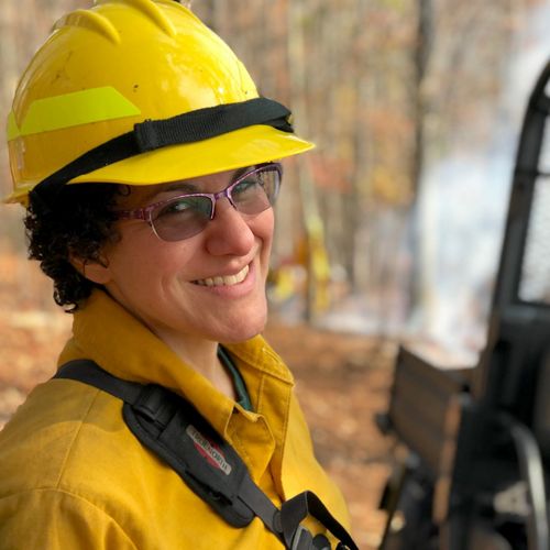 Candid headshot of Deborah Landau taken during a controlled burn.
