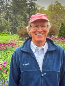 A photo of Jeff Rettig in a garden.