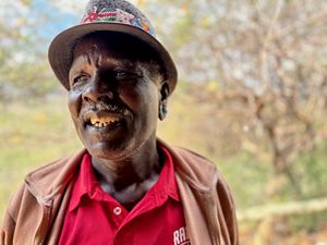 Indila Lesingiran, a community elder, showing off the community eco-lodge. © Mike Pflanz