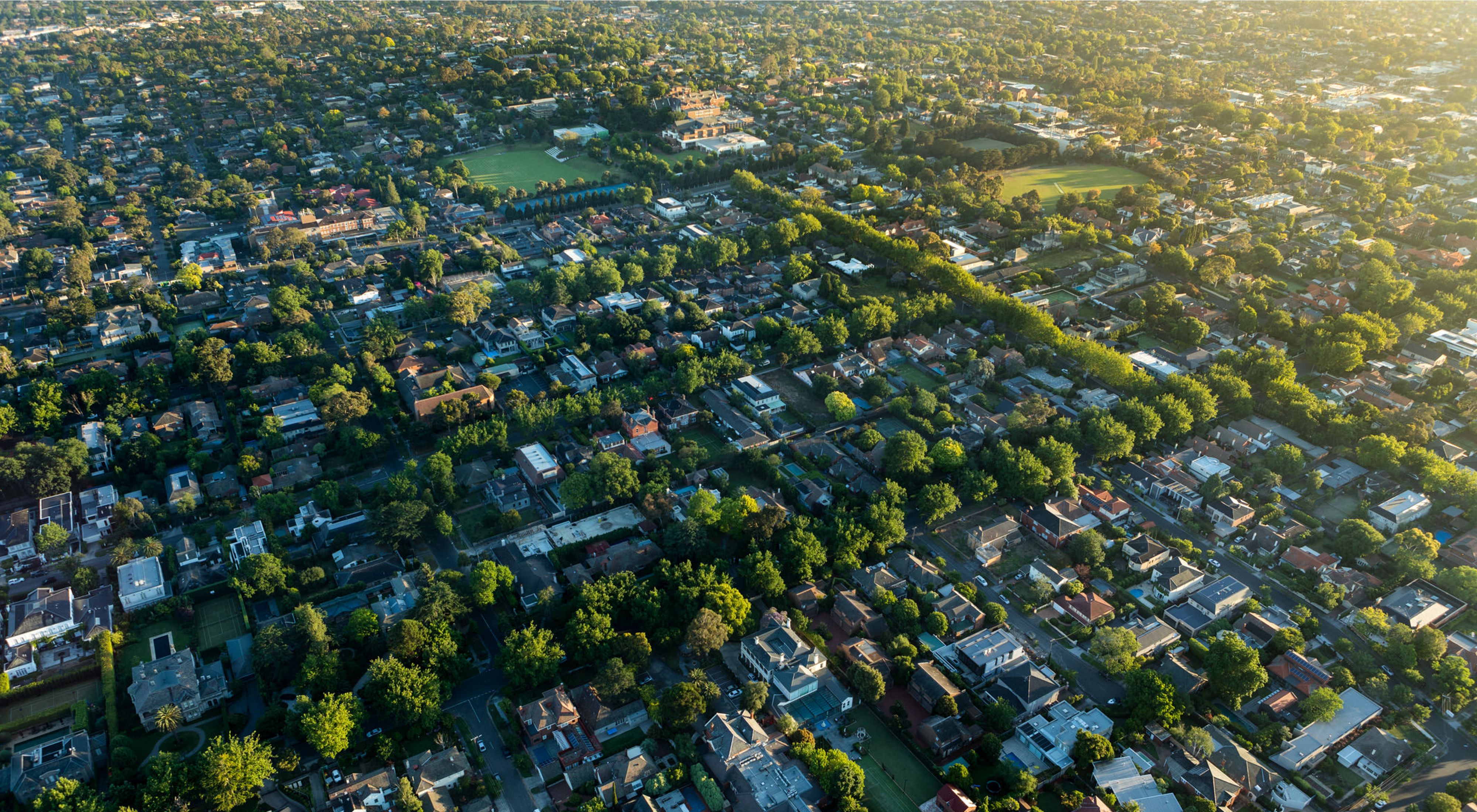 Aerial view of green Melbourne suburbs at sunrise