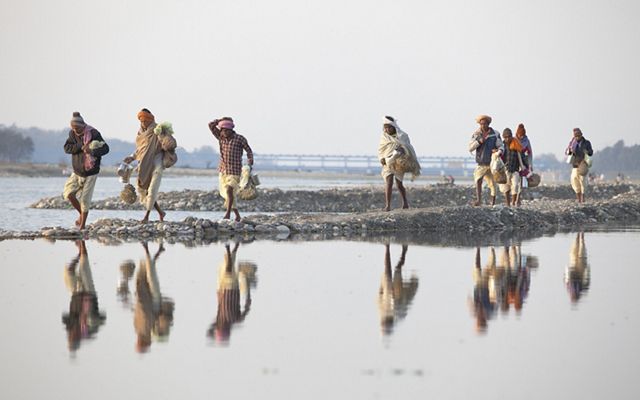 Villagers walk along the banks of the Ganges River in Haridwar.