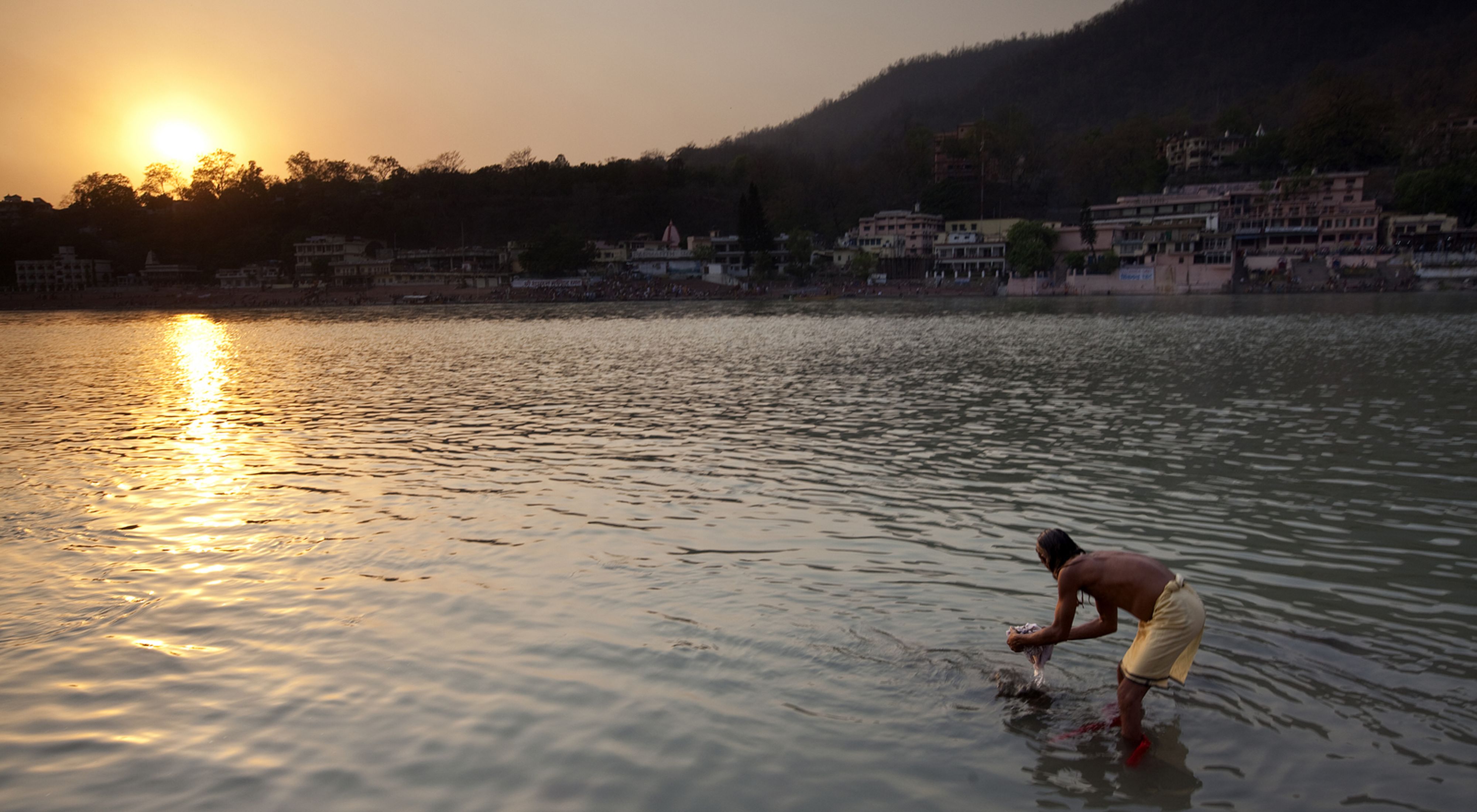 In Rishikesh, India, pilgrims bathe and gather at the Ganges River as part of the Kumbh Mela gathering.