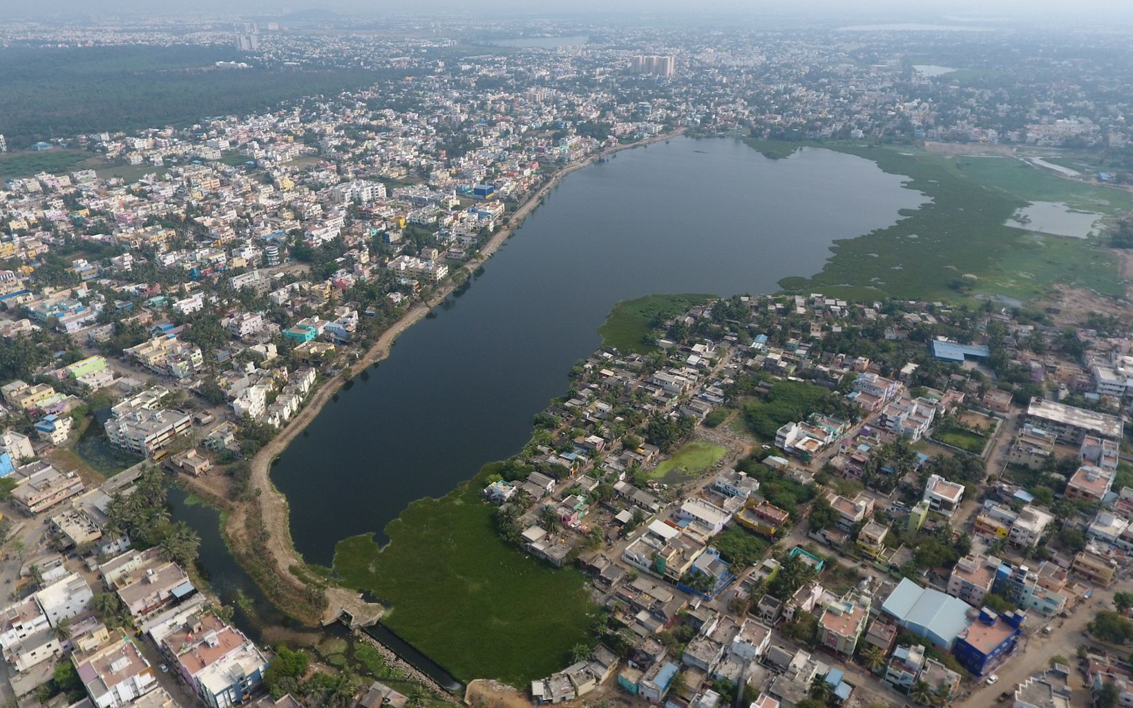 The Center of a Community Lake Sembakkam surrounded by buildings © TNC