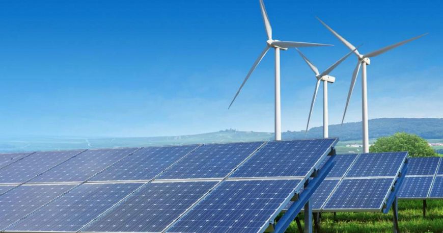 Solar panel row in front of wind turbines.