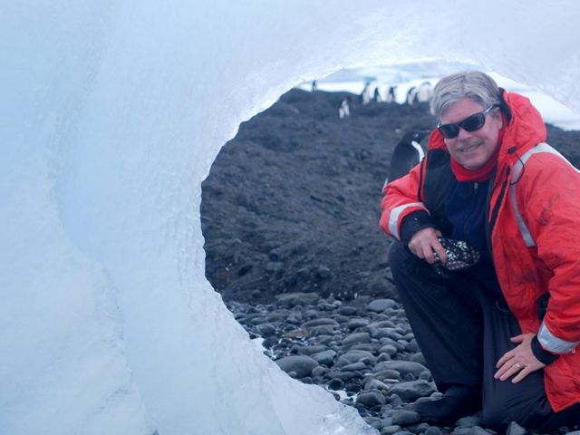 Dr. James McClintock in front of an iceberg.