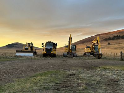 A row of yellow construction vehicles. 