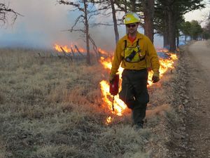 A burn boss lights a controlled burn on the preserve.