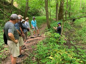 Hike leader speaks to small group of hikers on the trail at Big Walnut nature preserve.