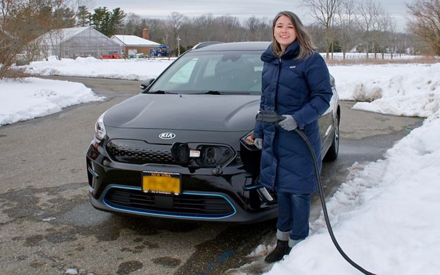 Price holds Uplands' new electric-vehicle (EV) charger, located in the front corner of the parking lot.
