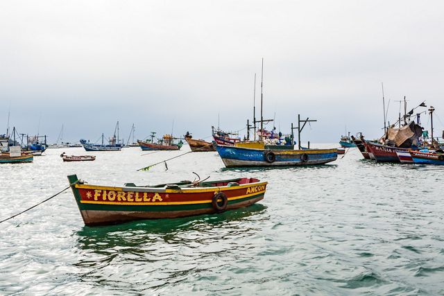 People enjoy playing on a beach in Ancon, Peru.