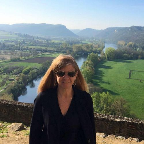 Jill Bieri stands in front of green fields.