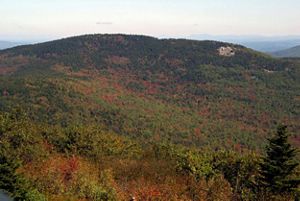 A mountain is covered in fall foliage.
