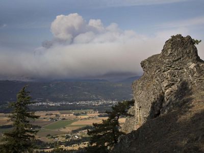 Wildfire burning smoke in the distance.