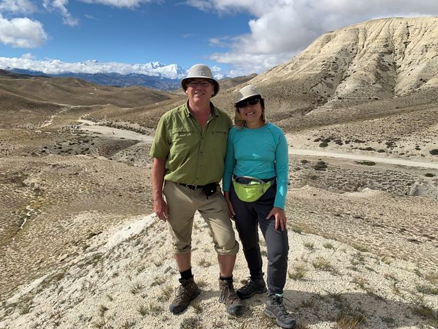 Jon Goulden and Kwok Lau posing for a photo with a desert view.