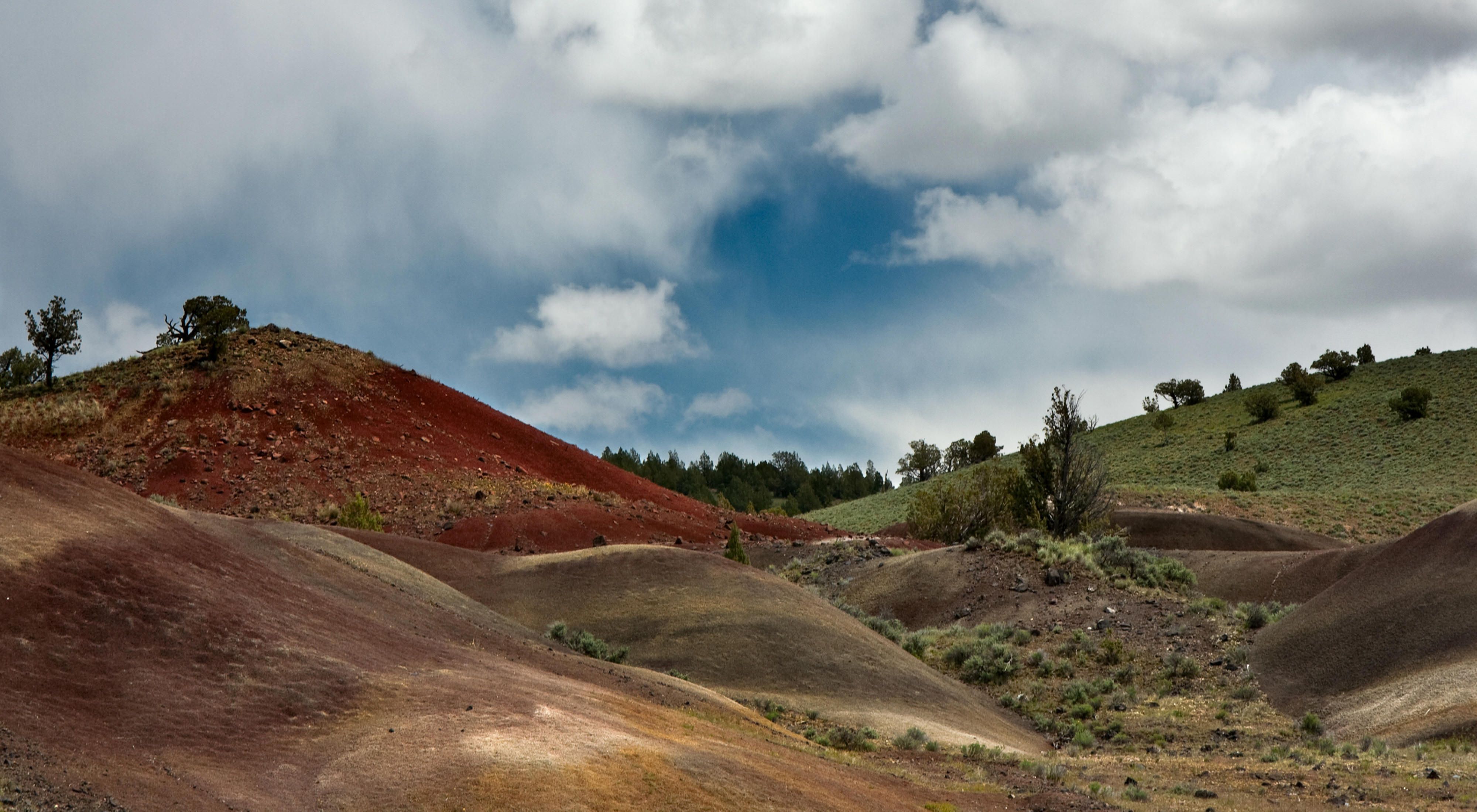 Red, rocky hills with scrubby vegetation.