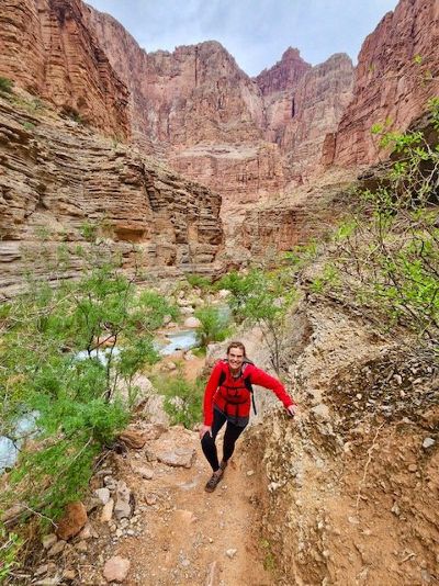 a woman hiking in a red rock canyon.