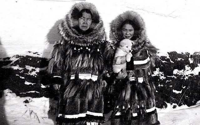 A black and white photo of a man and a woman in parkas
