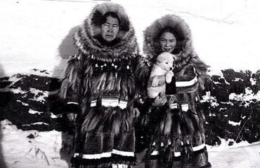 A black and white photo of a man and a woman in parkas