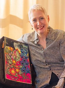 Artist Kay Khan displays her colorful nature-inspired backpack.