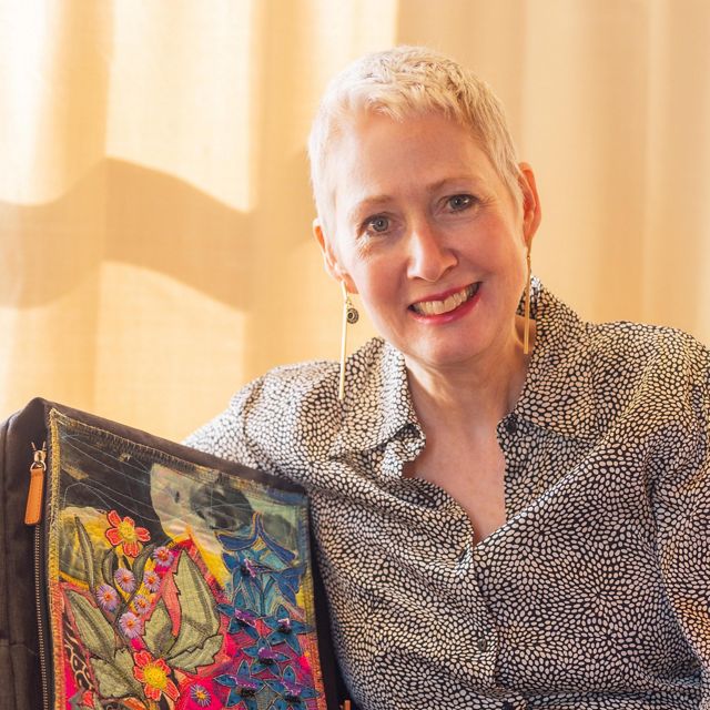Artist Kay Khan displays her colorful nature-inspired backpack.