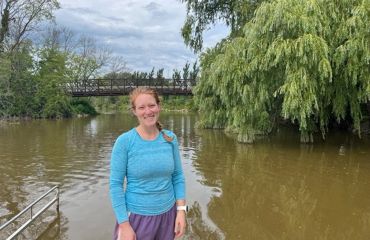Kayla Wandsnider stands in front of the East River.