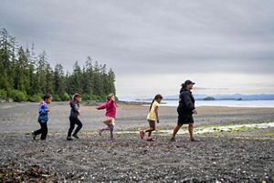 Kids running on the shore.