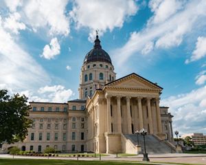 A large stone building with columns in front and a bronze dome at the top.