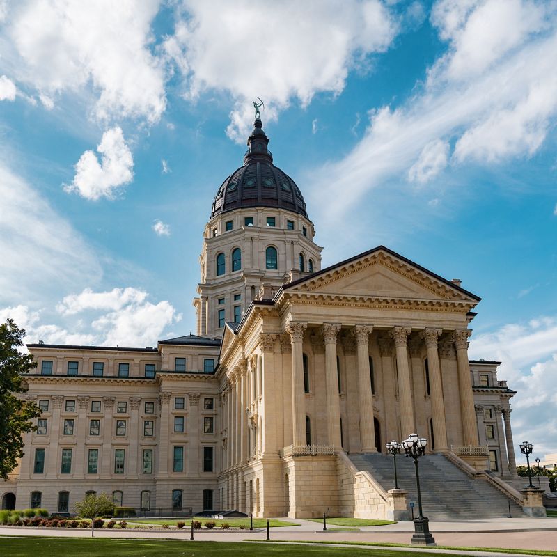 A large stone building with columns in front and a bronze dome at the top.