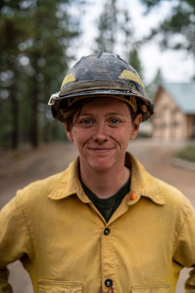 Portrait of Katie Sauerbrey in a yellow fire-protective shirt and a hard hat.