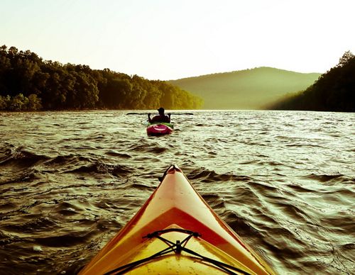 Two kayaks floating down a river.