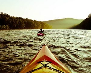 Two kayaks floating down a river.
