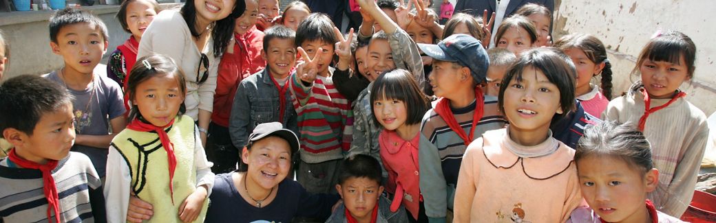 A large group of children smile for the camera.