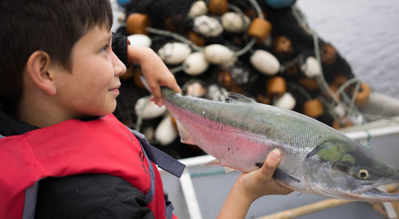 Boy with wild sockeye salmon