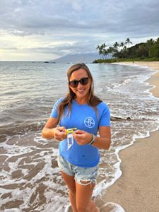 A woman with water sample on a beach. 