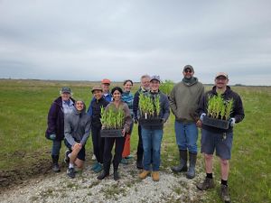 A group of people pose for a photo in a natural area.
