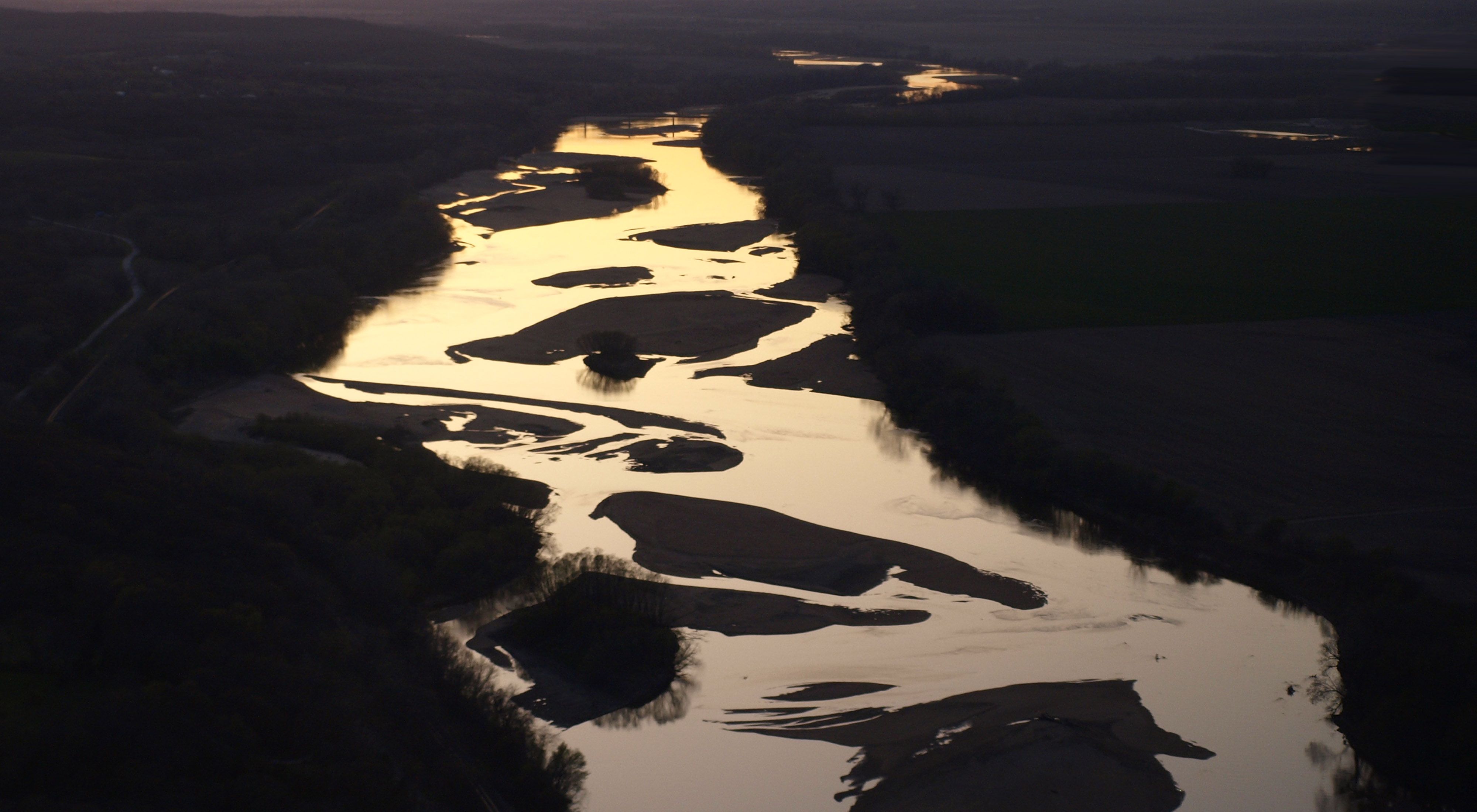 Aerial view of winding river with many sandbars.