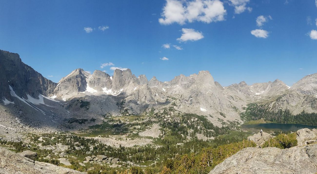 Dark gray rocky mountains with patches of snow on the slopes.