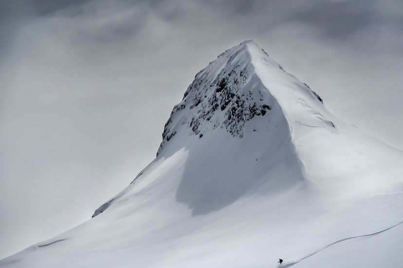 Skier heading down a mountain slope in Slovenia.