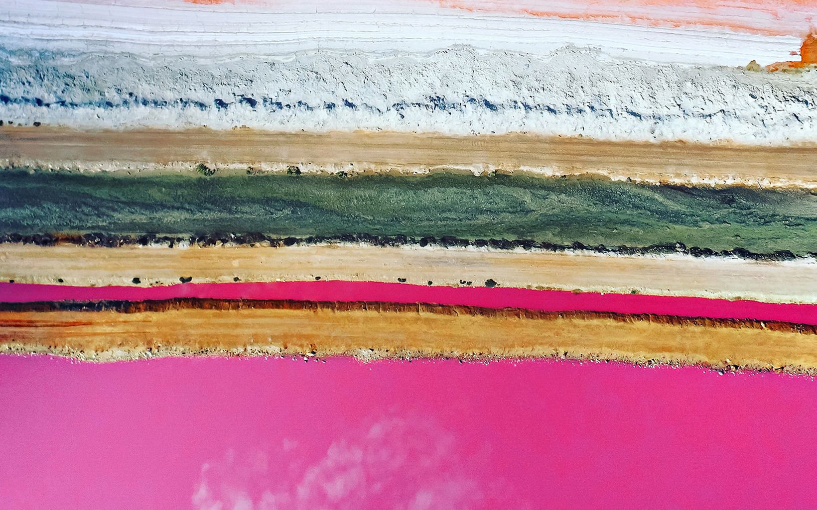 Drone photo showing the pink hues of a pink lake called Hutt Lagoon, Western Australia.