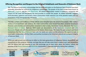 A sign includes black words typed onto the backdrop of a nature scene.